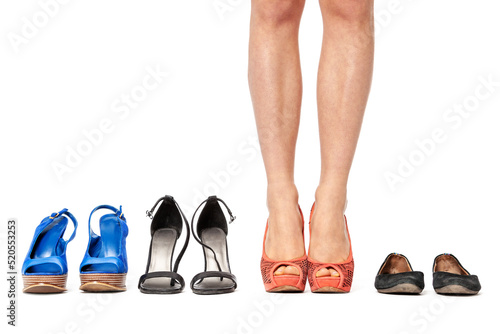 Closeup of woman choosing a pair of shoes - isolated on white.