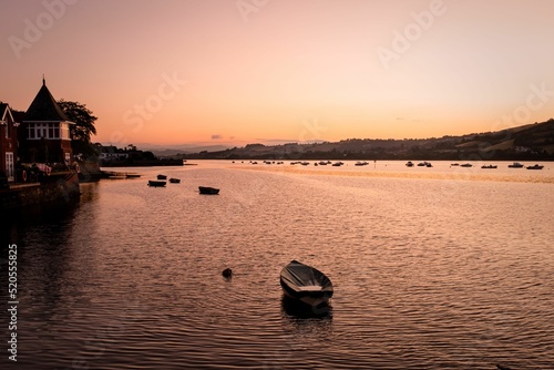 Beautiful shot of boats in Teign river in the sunset photo
