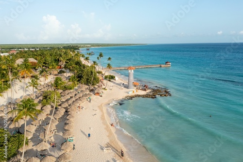 Bird's eye view of a beach with palms and a lighthouse in the Dominican Republic photo