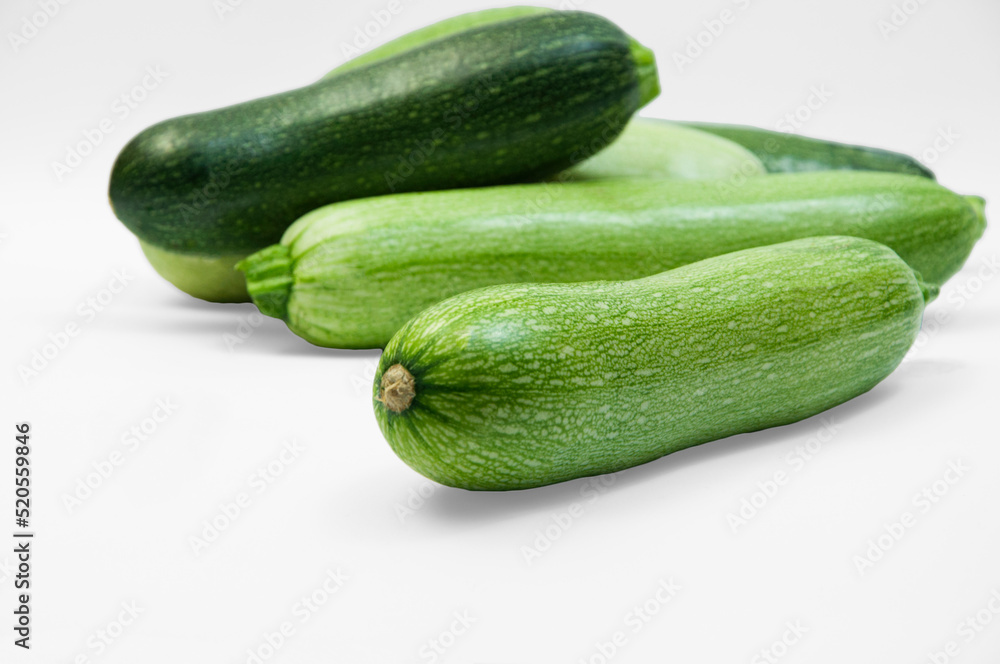 fresh zucchini on a white background. delicious green vegetables on the table. appetizing zucchini on a light texture. healthy food concept fresh zucchini on a white background. delicious green vegetables on the table. appetizing zucchini on a light texture. healthy food concept