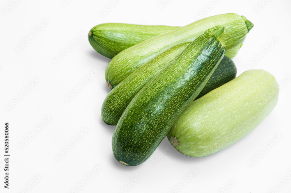 fresh zucchini on a white background. delicious green vegetables on the table. appetizing zucchini on a light texture. healthy food concept fresh zucchini on a white background. delicious green vegetables on the table. appetizing zucchini on a light texture. healthy food concept