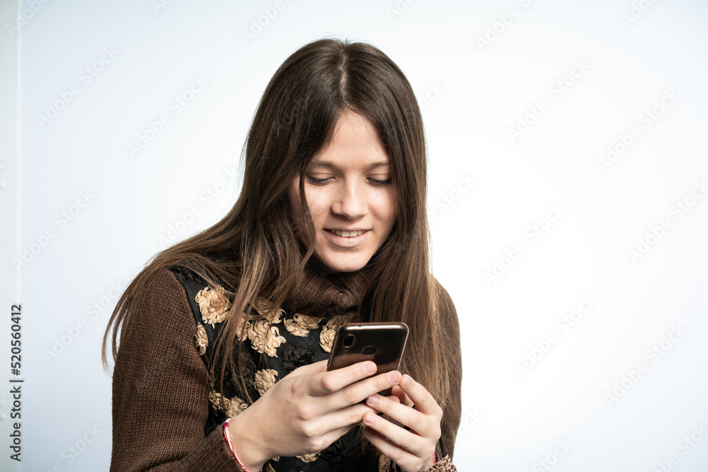 Young beautiful woman is having fun with smartphone Young beautiful woman is having fun with smartphone