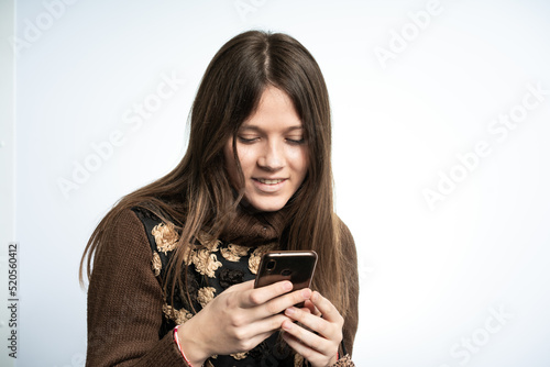 Young beautiful woman is having fun with smartphone