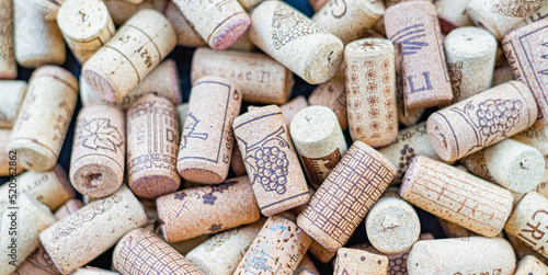 Wine corks pile full frame natural background closeup. Wine corks as background. Flatlay view.