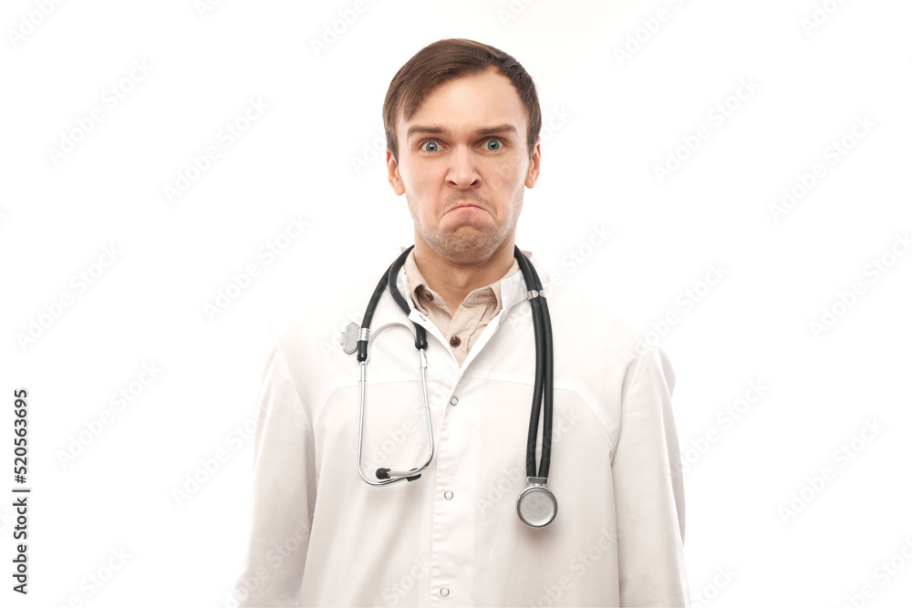Portrait of angry doctor in white medical coat with stethoscope upset face screaming on white background with copy space Portrait of angry doctor in white medical coat with stethoscope upset face screaming on white background with copy space