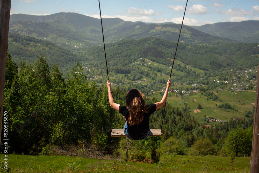 Girl on a mountain swing