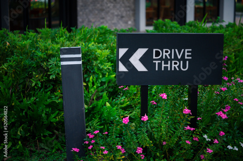 Coffee and food drive thru sign with flower garden