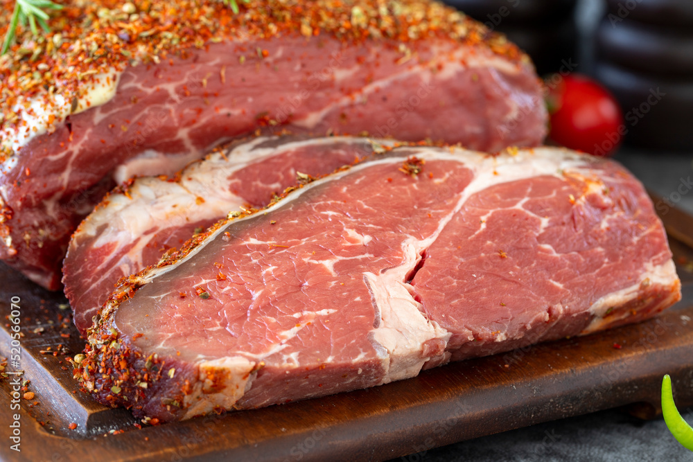 Special entrecote. Beef entrecote specially prepared with spices on a dark background. Butcher products. close up Special entrecote. Beef entrecote specially prepared with spices on a dark background. Butcher products. close up