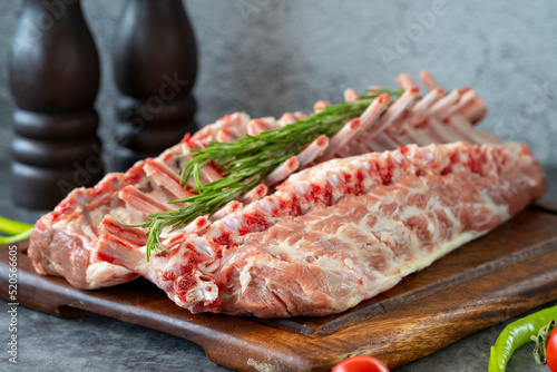 Lamb chops. Whole fresh lamb chop or rib chop on dark background. Butcher products. close up photo