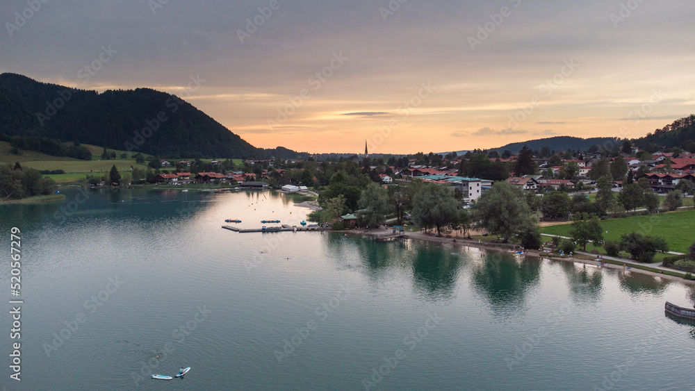 Orange evening light shining on a small German village in the Alps at the Schliersee