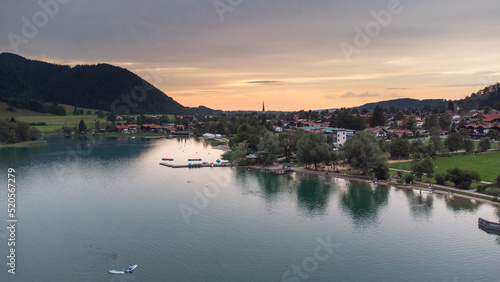 Orange evening light shining on a small German village in the Alps at the Schliersee © Pablo