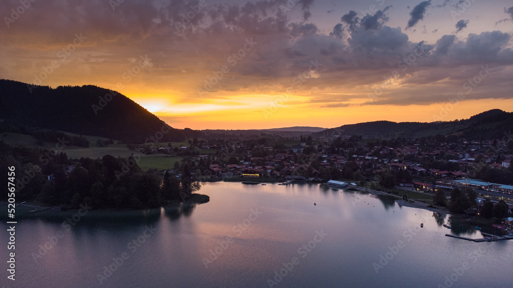 Orange evening light shining on a small German village in the Alps at the Schliersee