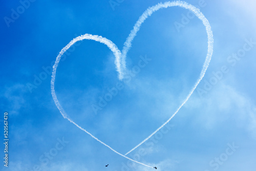 Two Light Airplanes In The Sky Writing Romantic Heart Shape