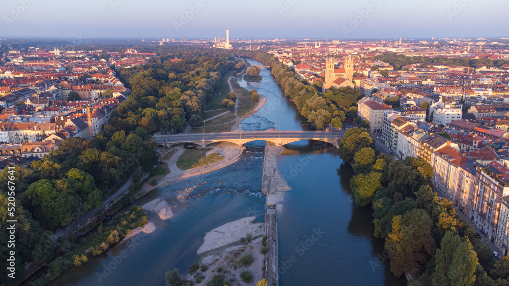 Isar river flowing through the city of Munich in a calm summer morning aerial image