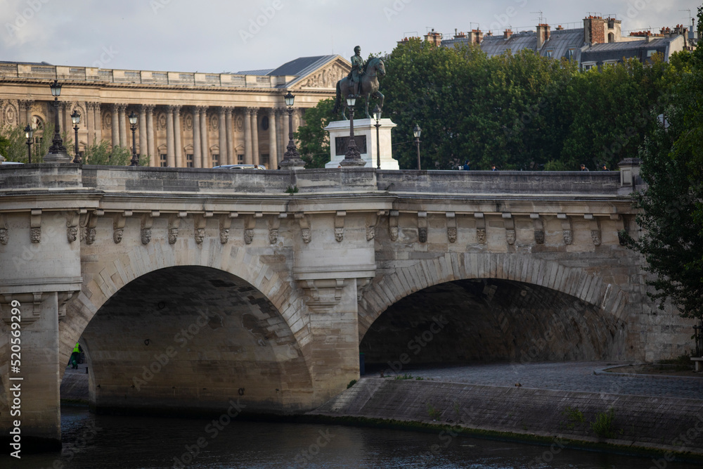 The Pont Neuf over the Seine River in the French city of Paris with beautiful monuments. Paris is divided by the Seine river and this beautiful European city is full of beautiful bridges.