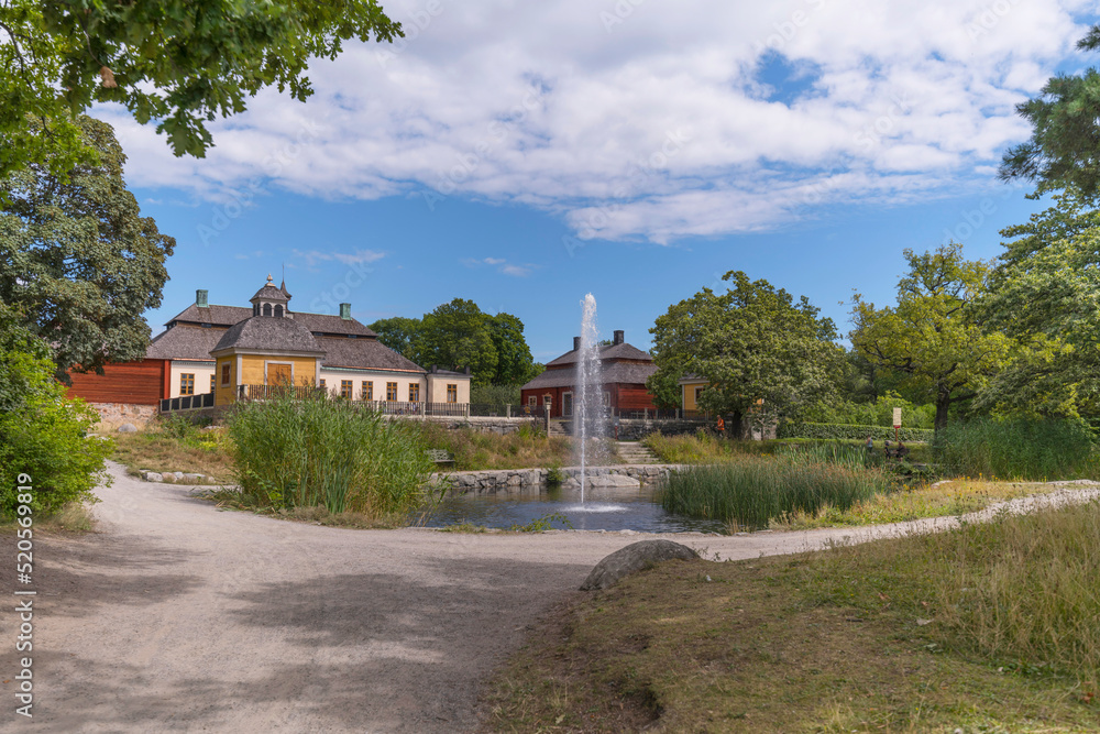 Old mansion farm houses and a fountain dam, a sunny summer day in Stockholm