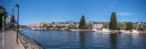 Apartment houses at the water front districts Nacka and Hammarby sjöstad, Canal boat Diana passing for the town Göteborg a sunny summer day in Stockholm