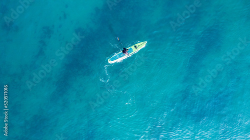 People practicing paddleboarding on the sea