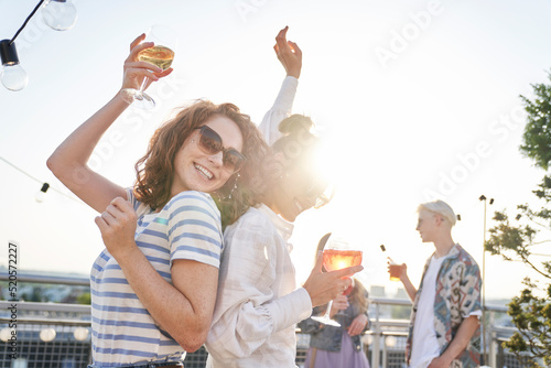 Sticker Two caucasian women dancing at the rooftop in summer day