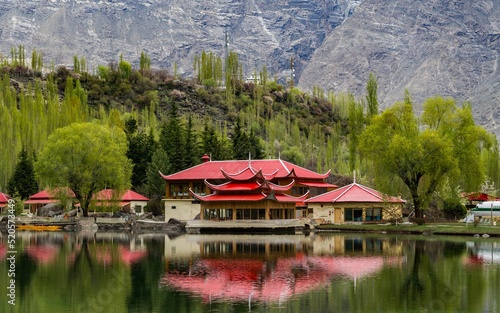 Asian red-roof buildings on the shore of Upper Kachura Lake in Skardu, Pakistan photo