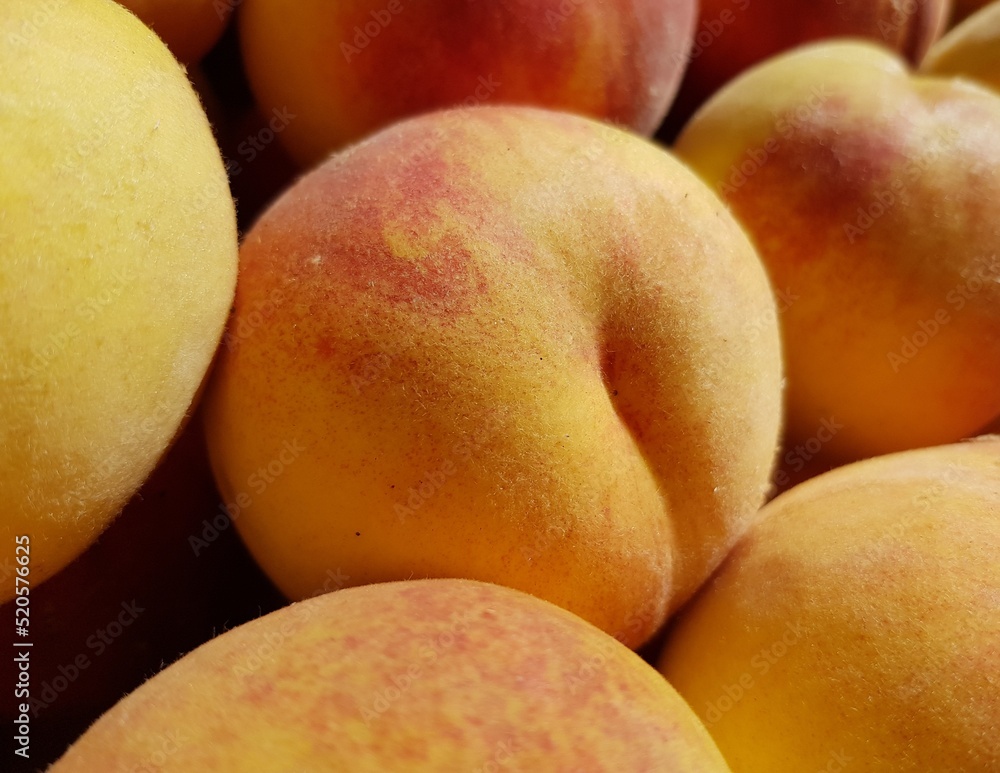 Ruddy fresh peaches (Prunus persica) in the sun (macro, top view, texture). Ruddy fresh peaches (Prunus persica) in the sun (macro, top view, texture).