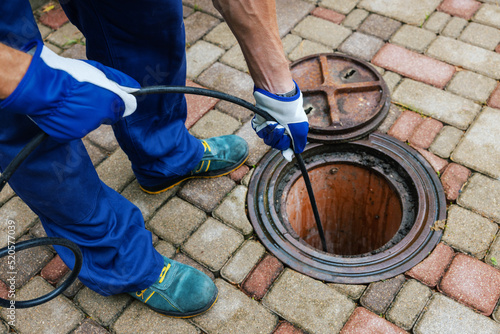 sewer cleaning service - worker clean a clogged drainage with hydro jetting photo