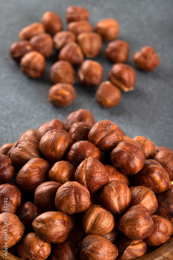 Top view of a bowl full of hazelnuts on dark background
Top view of a bowl full of hazelnuts on dark background