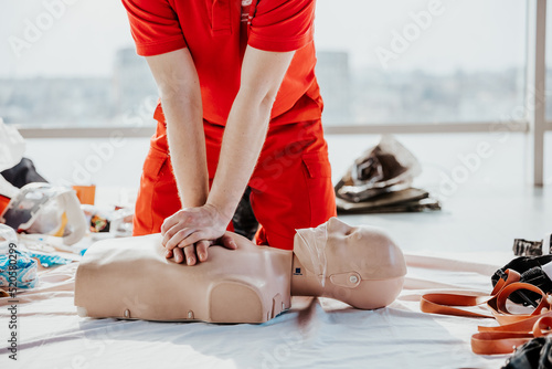 26.03.2022 Kyiv, Ukraine: CPR training medical procedure, Demonstrating chest compressions on CPR doll in the office of modern company photo
