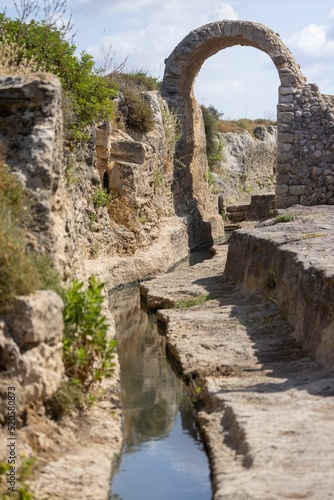 Vertical shot of Nahal Taninim river along ruined ancient dam photo