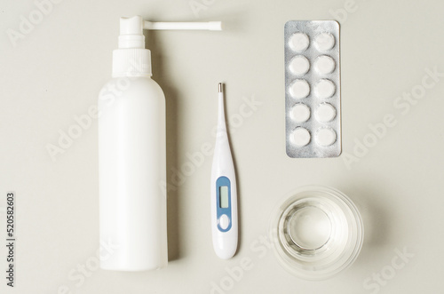 Medical electronic thermometer, nasal spray and tablets. The concept of diagnosis and treatment of a runny nose or flu or sore throat.