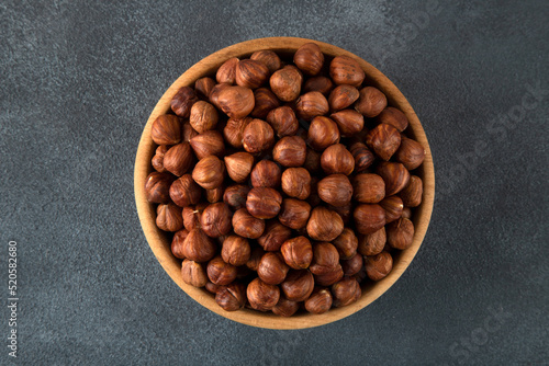 Top view of a bowl full of hazelnuts on dark background  © Wide Angle