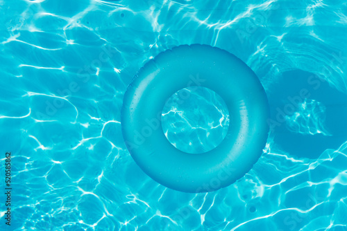 Blue summer pool rubber ring floating on a vacation swimming pool