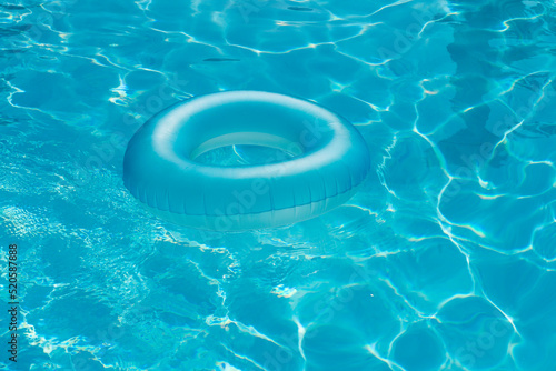 Blue summer pool rubber ring floating on a vacation swimming pool