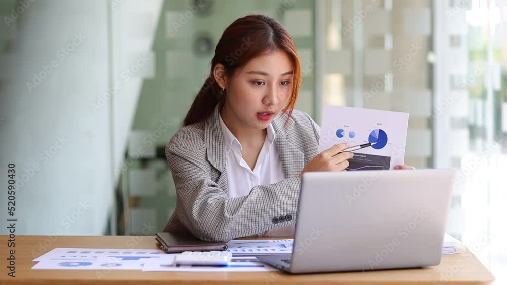 Asian woman work from home online meeting with business team presenting finance report. Video Conference of business woman working and talking with colleague from home. Asian woman work from home online meeting with business team presenting finance report. Video Conference of business woman working and talking with colleague from home.