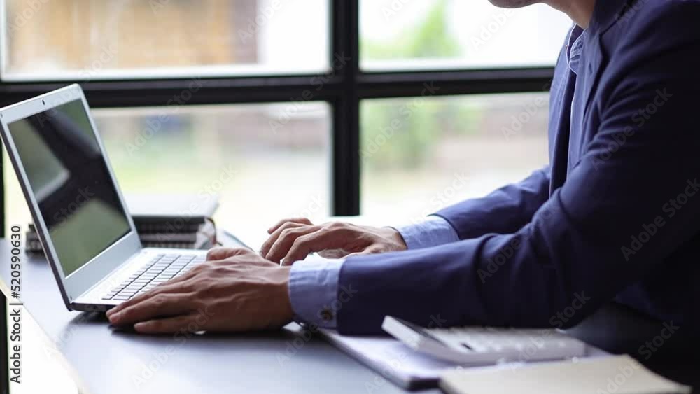 Business man working on a laptop typing. Business man working on a laptop typing.