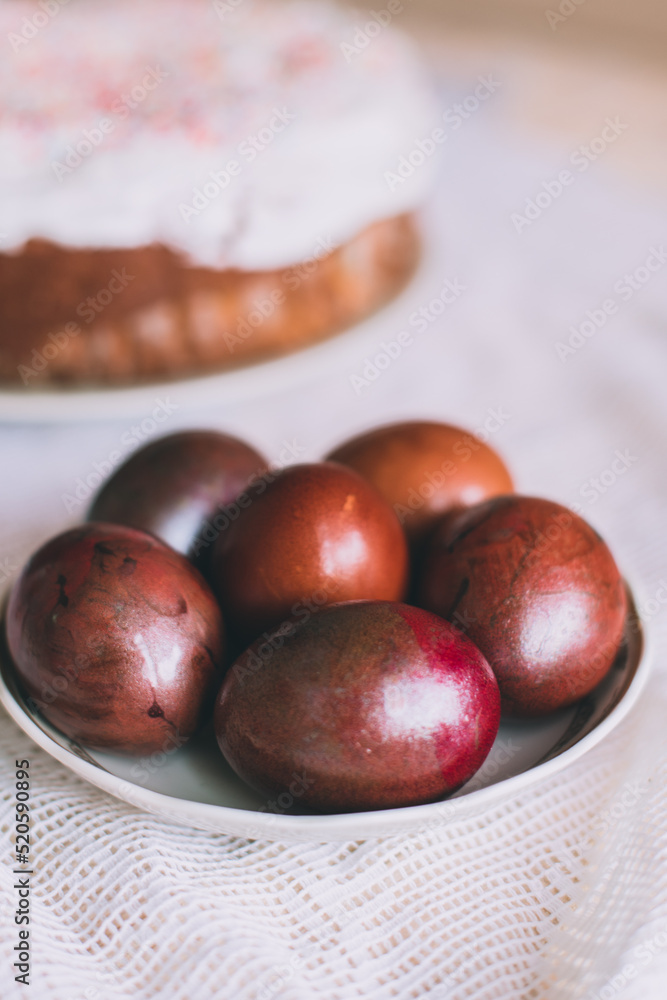 Obraz premium Easter table with traditional Easter cakes and Easter eggs with blossoming tree branch
