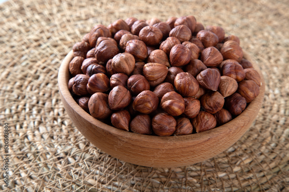 Bowl full of hazelnuts on wooden background
Bowl full of hazelnuts on wooden background