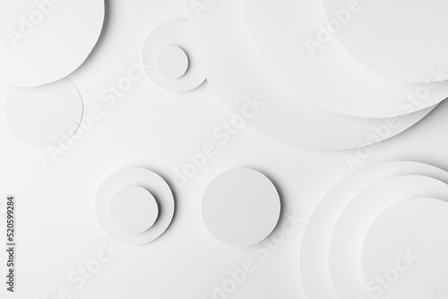 White abstract geometric background with fly soft light white circles and semicircle stepped surfaces as monochrome stylish pattern in elegant simple modern minimal style, top view.