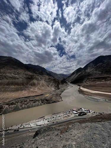 Vertical shot of the confluence of Indus and Zanskar rivers in Nimmoo valley, Ladakh, India photo