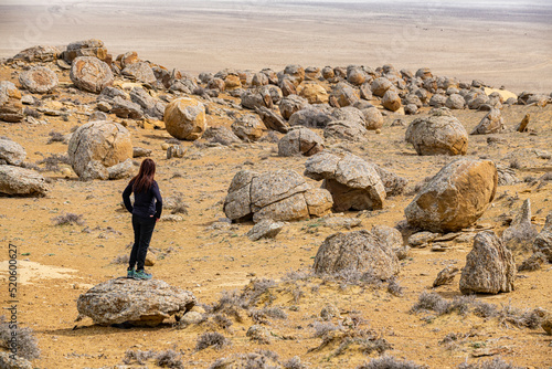 Woman standing in the Torysh (The Valley of Balls), Shetpe, Mangystau, Kazakhstan photo