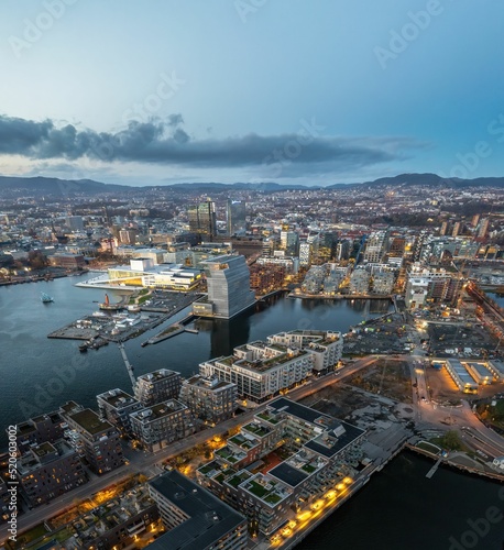 Aerial shot of Oslo, with lots of buildings and lights, surrounded by sea, Norway