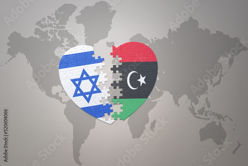 puzzle heart with the national flag of libya and israel on a world map background.Concept.