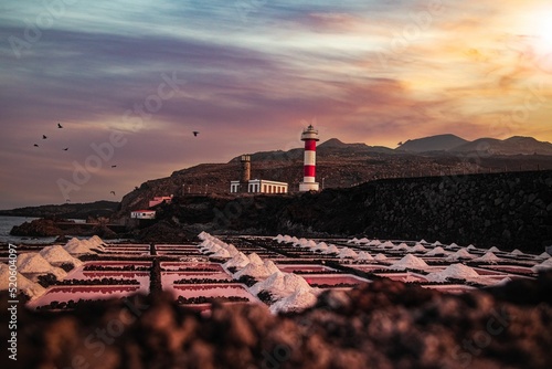Beautiful shot of Lighthouses in the back of ground full of Salt piles during sunset in Fuencaliente photo