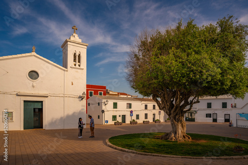 View of Sant Antoni de Fornells church in whitewashed street in Fornelles, Fornelles, Menorca, Balearic Islands, Spain photo