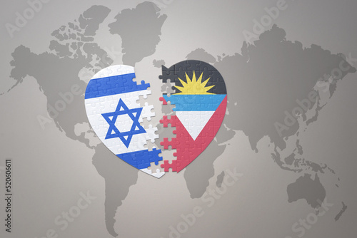 puzzle heart with the national flag of antigua and barbuda and israel on a world map background.Concept.