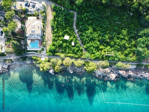 Drone shot of house with green space by the sea in Moscenicka Draga, Croatia photo