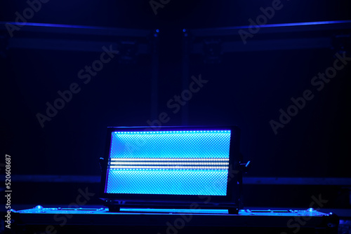 The stage lighting device stands on boxes with equipment