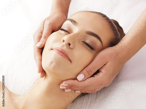 Print op canvas Beautiful, young and healthy woman having face massage in spa salon