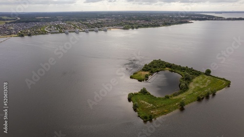 Breathtaking aerial view of the Gooimeer lake and the Huizerhoef island in Almere, Netherlands photo