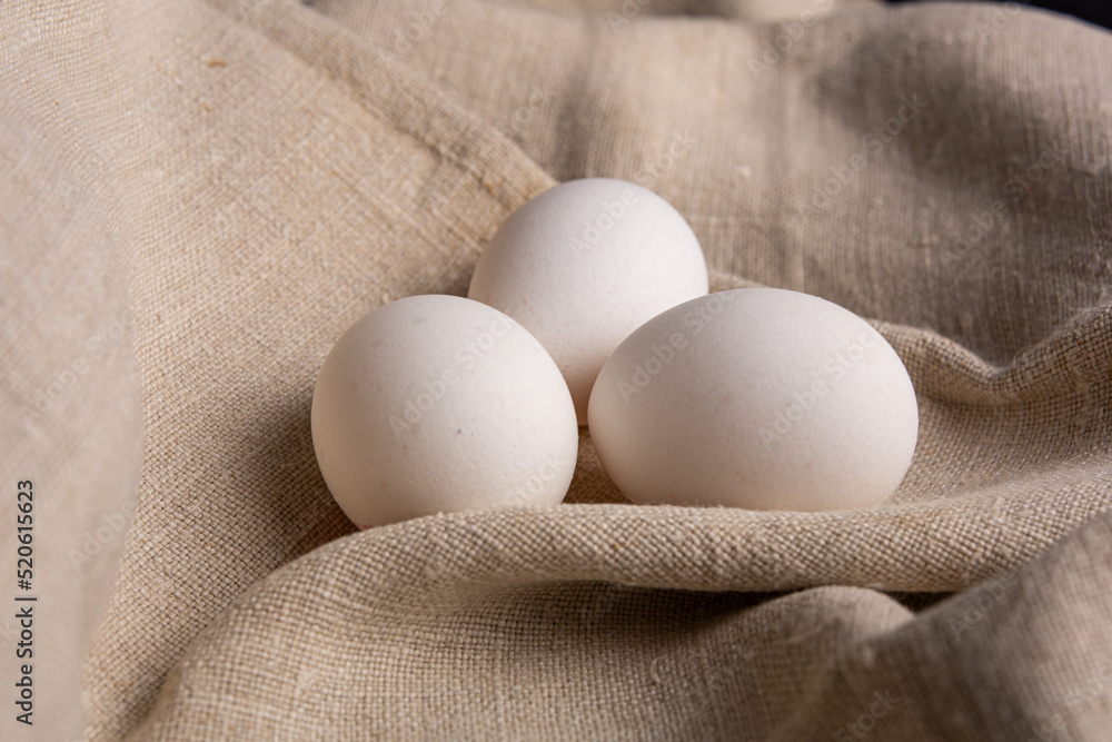 Chicken white eggs on burlap. Farm products. Natural eggs. Chicken eggs on the table. Chicken white eggs on burlap. Farm products. Natural eggs. Chicken eggs on the table.